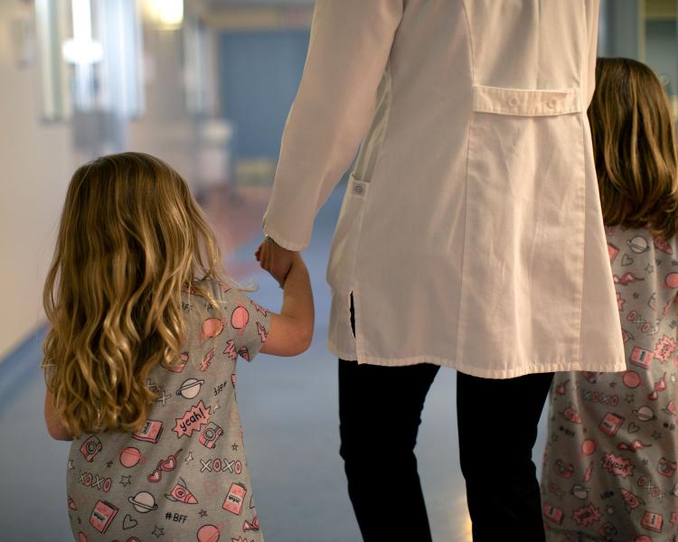image of children walking with nurse